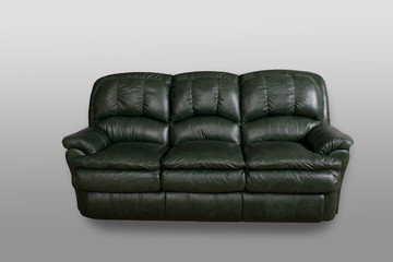 Green leather sofa on a gray background in the studio 