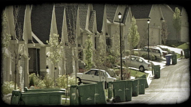 Street of identical housing units. Vintage stylized video clip.