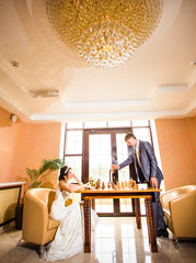couple playing chess on wedding day