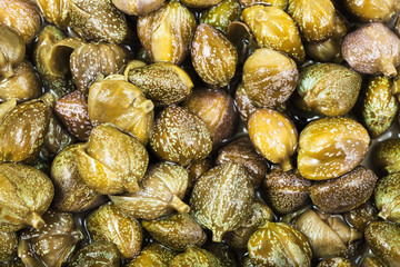 many green pickled capers close up