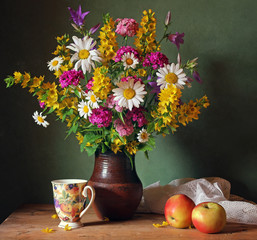 Still life with a bouquet of summer flowers in a clay jug. © Masquerade