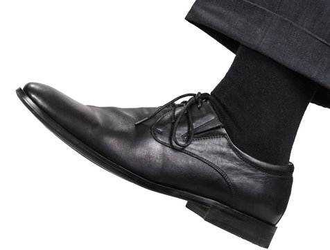 male left leg in black shoe takes a step