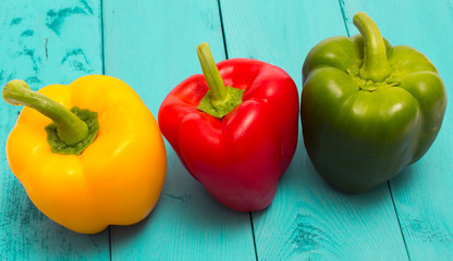 Fresh red, green and yellow peppers