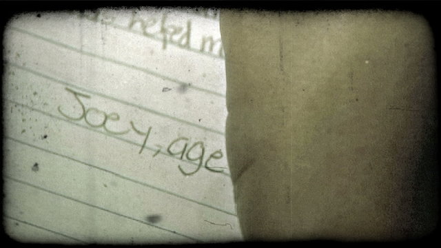 Young boy finishes letter. Vintage stylized video clip.