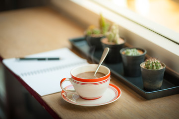 Coffee cup on wood bar in cafe