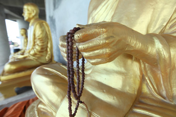 Row of golden seated buddhas