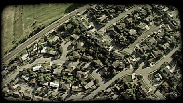 Aerial over homes 2. Vintage stylized video clip.