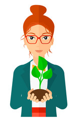 Woman holding plant.