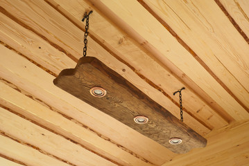 Suspended ceiling light in the form of an oak board with lights
