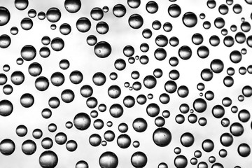 Oxygen bubbles in water on a black and white background