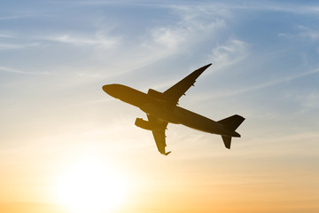Fototapeta na wymiar airplane silhouette on a sunset background
