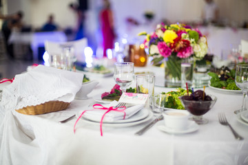Elegantly catered luxury white tableware at wedding reception cl