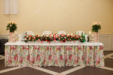 Beautiful and elegant wedding reception table covered with flowe