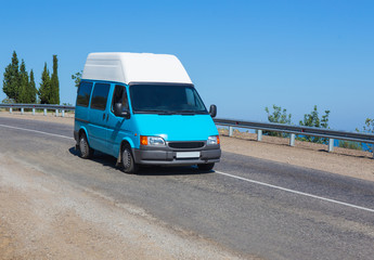 Fototapeta na wymiar minibus goes on mountain road