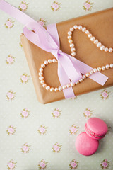 Obraz na płótnie Canvas Gift box with pearls in a romantic vintage style in pastel color