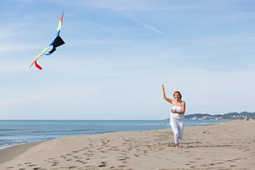 redheaded model holding kite and posing 