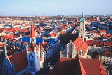 Naklejka premium Beautiful super wide-angle sunny aerial view of Munich, Bayern, Bavaria, Germany with skyline and scenery beyond the city, seen from the observation deck of St. Peter Church 