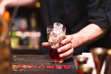 Bartender preparing a cocktail. Glass on the bar