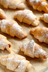 Fresh homemade croissants on a brown parchment