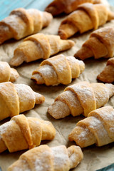 Fresh homemade croissants on a blue wooden table