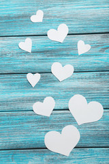 White hearts on a blue wooden table