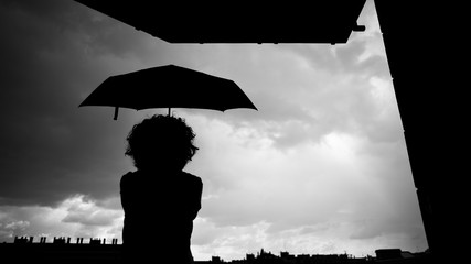 Silhouette of a woman with an umbrella