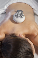 spa massage, beautiful woman lying on a stretcher receiving trea