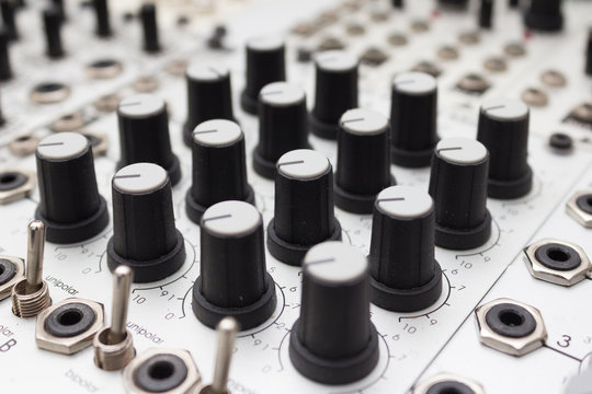 analog synthesizer , knobs macro on music equipment