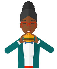 Woman eating hamburger. 