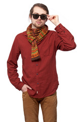 Man in a red shirt, bright scarf and sunglasses