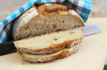 Slices of freshly baked rye bread on wooden board
