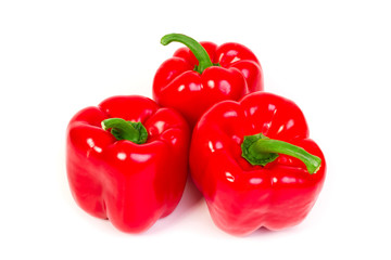 three sweet red peppers - isolated