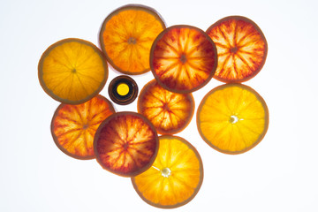 essential oil with blood orange slices with back light