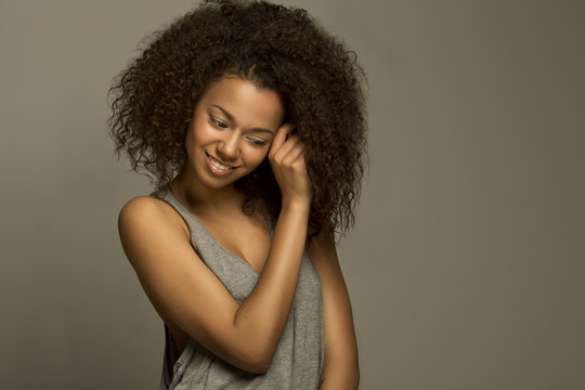 Portrait of a beautiful natural young African afro woman smiling happiness