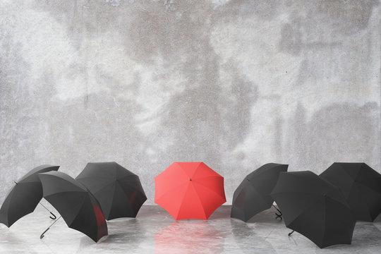 Group of black and one red umbrella