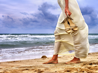 Summer girl sea.  Woman goes on coast. Low section.