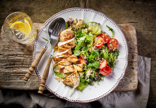 Quinoa and vegetable salad and grilled chicken