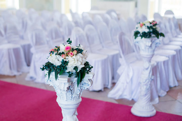 Beautiful wedding ceremony design decoration elements with arch, floral design, flowers, chairs and balloons
