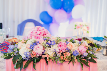 Beautiful wedding interior and table decor, flower decoration with flowers bouquet, with roses, tulips, peonies