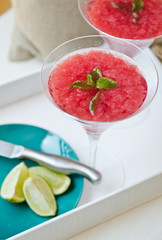 Strawberry Daiquiri cocktail with slices of lime and mint