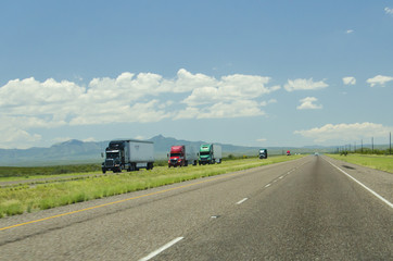 A highway in New Mexico, packed with many truck trailers. 