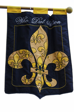 A flag with a fleur-de-lis, symbol of New Orleans, and Who Dat Nation text.