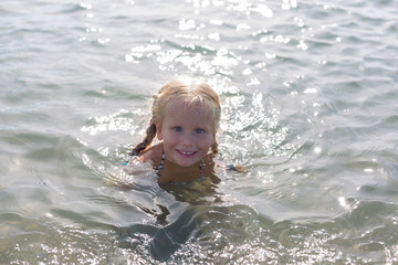 Fototapeta na wymiar happy girl sitting in the sea