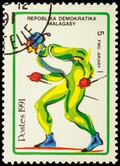 Colored picture of running skier on post stamp