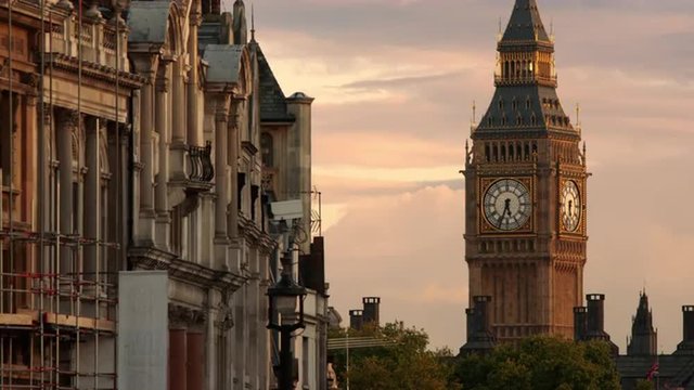 The top of Big Ben seen with buildings in the foreground.