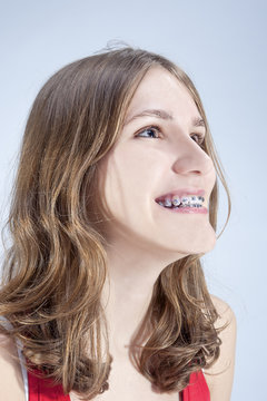 Caucasian Teenage Girl Showing Her Teeth Brackets