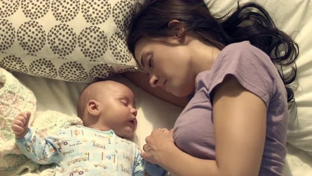 Royalty Free Stock Footage of Mother and baby taking a nap together.