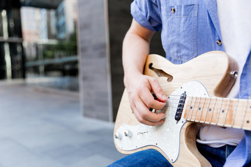 Hands of musician with guitar