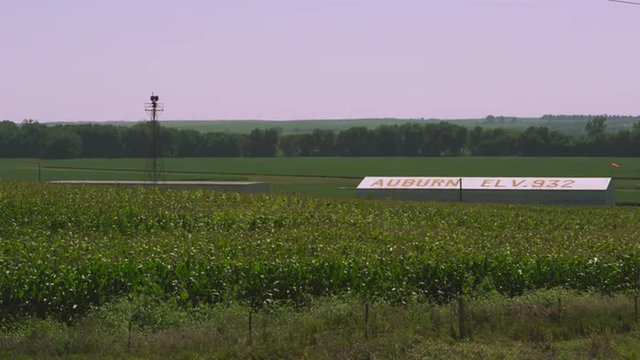 Static shot of corn field and buildings.