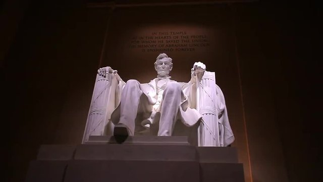 Static shot of Abraham Lincoln statue at the Lincoln Memorial in Washington DC at night